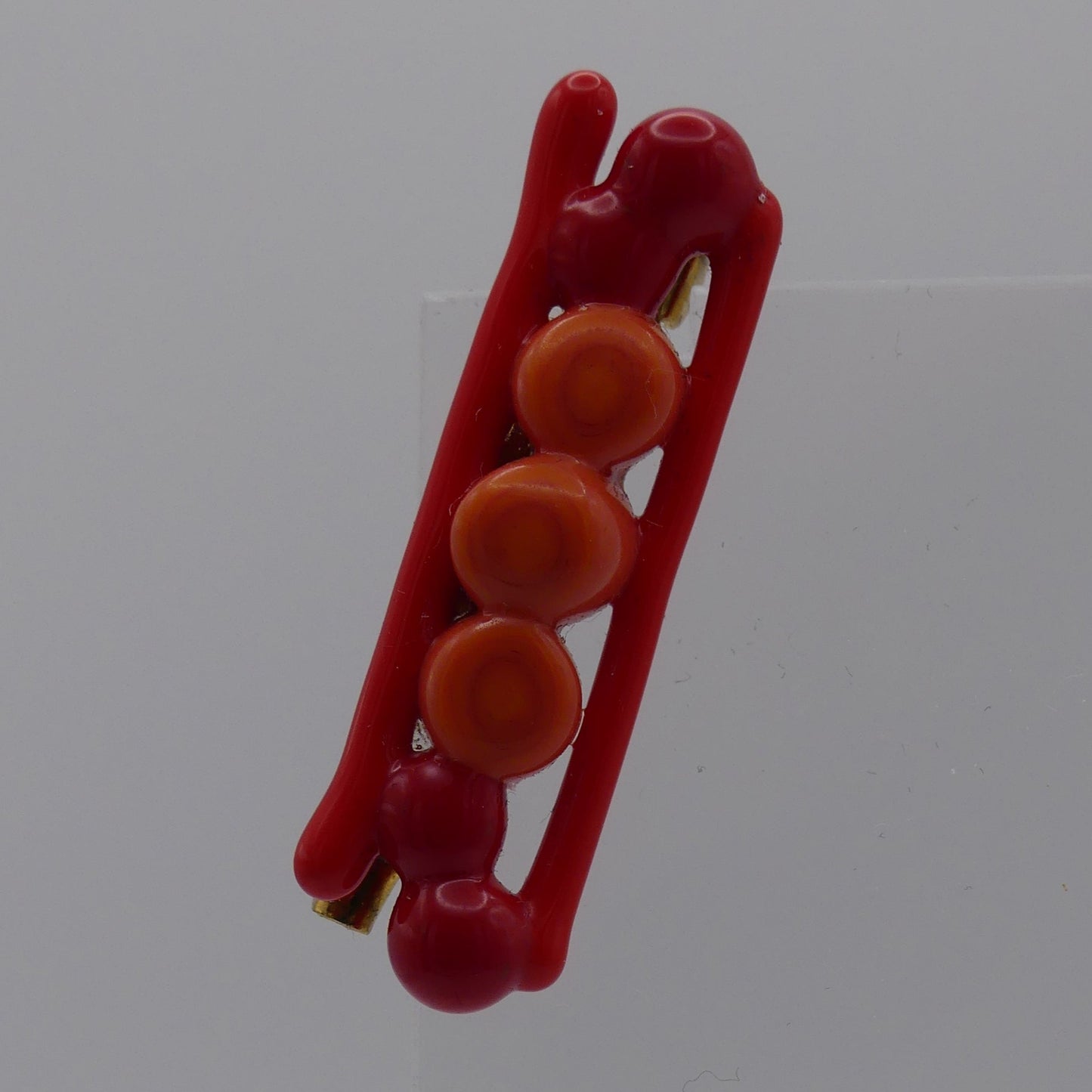 Broche rouge orange